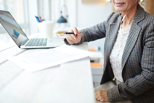 Businesswoman sitting in cafe and reading paper