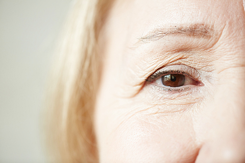 Sad eye of elderly blond-haired woman , close-up shot