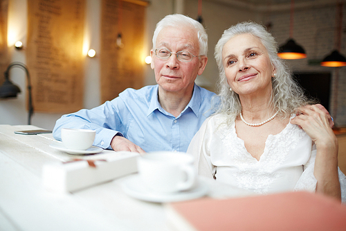 Senior husband and wife spending time in cafe