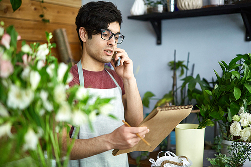 Florist ordering new sorts of flowers by phone