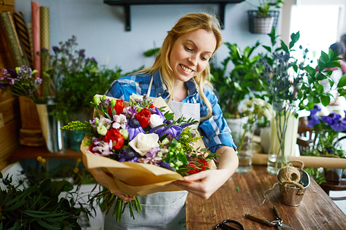 Happy florist with beautiful bouquet
