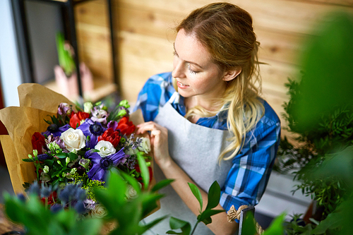 Owner of flower-shop looking at bouquet