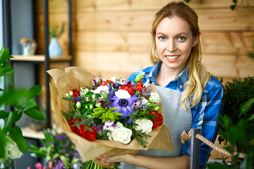 Happy florist with bunch of flowers 