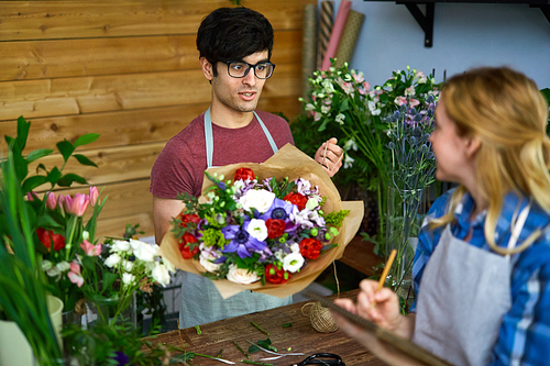 Young florists discussing new sorts of flowers