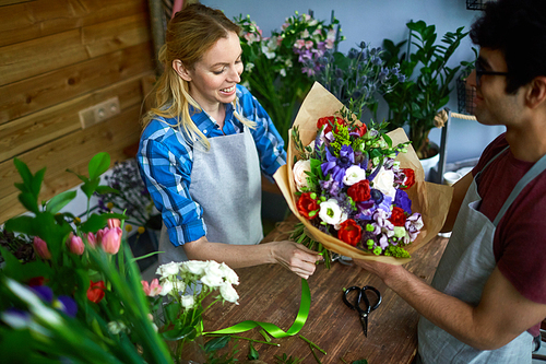 Young man and woman working in flower shop