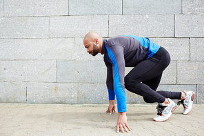 Fit young man exercising against wall