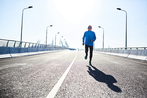 Outline of active sportsman running forwards along cycling road