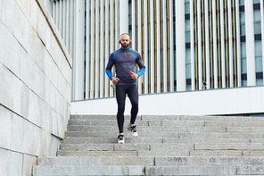 Active guy in sportswear running downwards