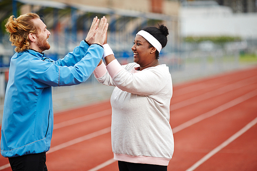 Trainer congratulating one of his trainees on sport achievement