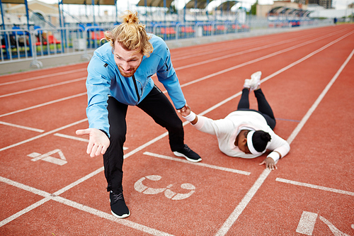 Strict male coach dragging his exhausted plump client towards finishing line