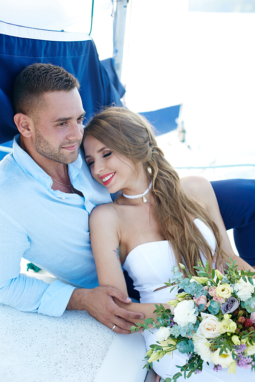 Serene and peaceful couple enjoying their honeymoon on yacht