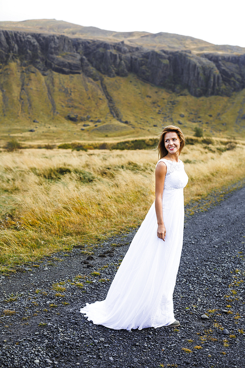 Happy young bride in white gown during honeymoon journey