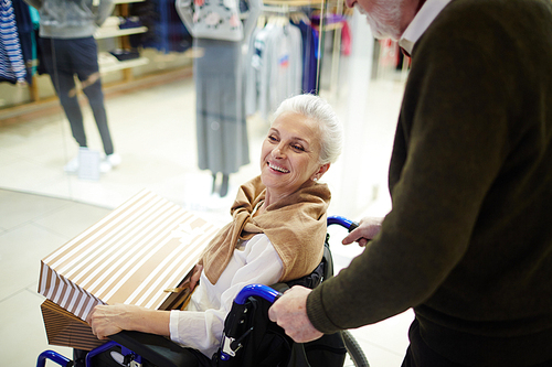 happy . woman talking to her caregiver during shopping