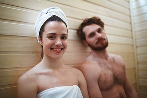 Relaxed young couple enjoying time in sauna