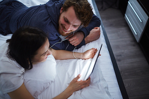 Young affectionate couple watching something curious online