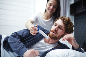 Woman showing her husband positive pregnancy-test