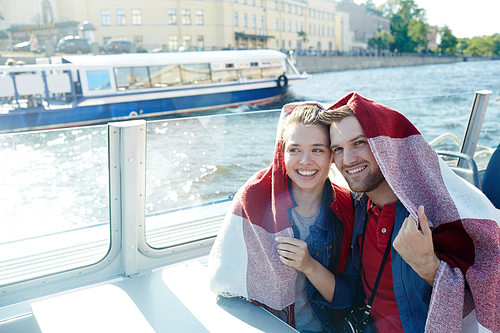 Couple in plaid floating in steamship on summer day