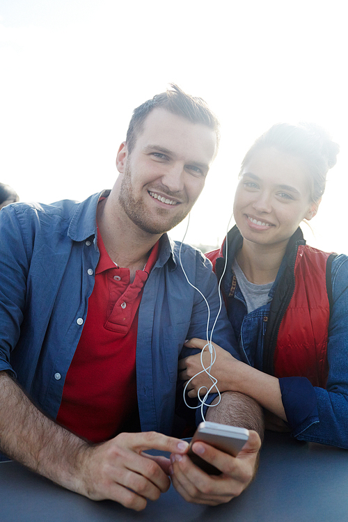 Amorous couple listening to music while traveling