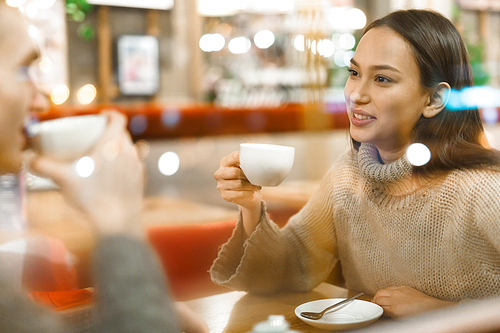 Amorous couple having pleasant time in cafe by cup of tea