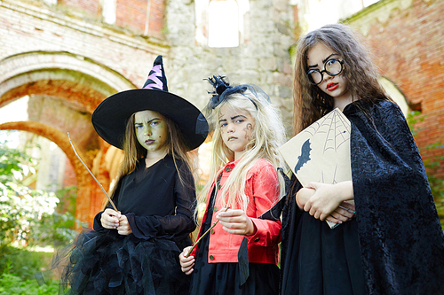 Group of gloomy halloween girls wearing traditional costumes
