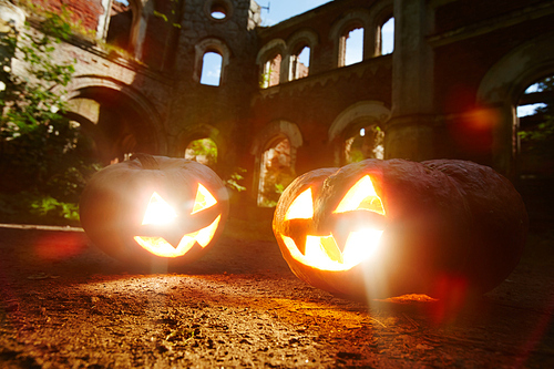 Evil grins of jack-o-lanterns burning on halloween night