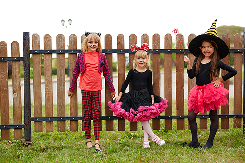 Pretty girls in witch costumes celebrating halloween outdoors
