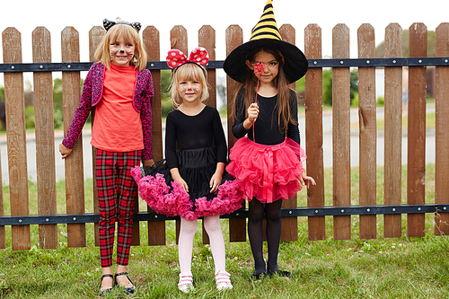 Group of friendly girls wearing traditional halloween costumes