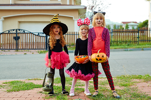 Trick-or-treat girls asking for candies on day of halloween