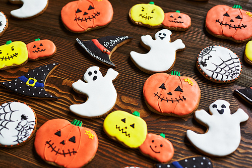Background of decorative halloween cookies on wooden table