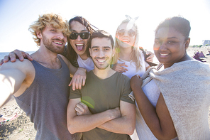 Carefree teens making selfie on the beach on sunny day