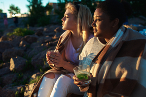 Serene girls enjoying summer evening on the beach