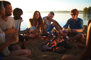 Friends by campfire making fried marshmallows