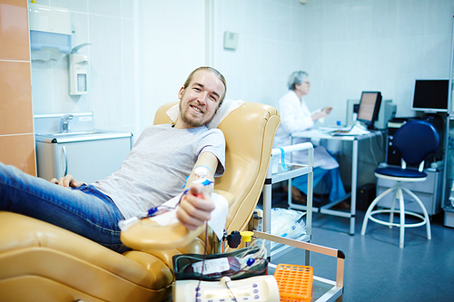 Young donor giving his blood for people in need