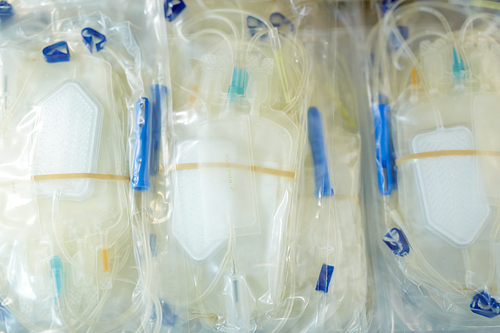 Background of empty blood bags and drips in airtight packs