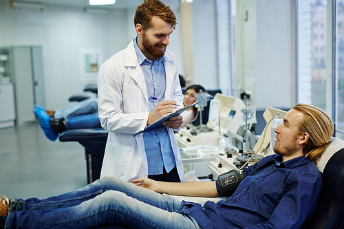 Doctor in whitecoat consulting young donor