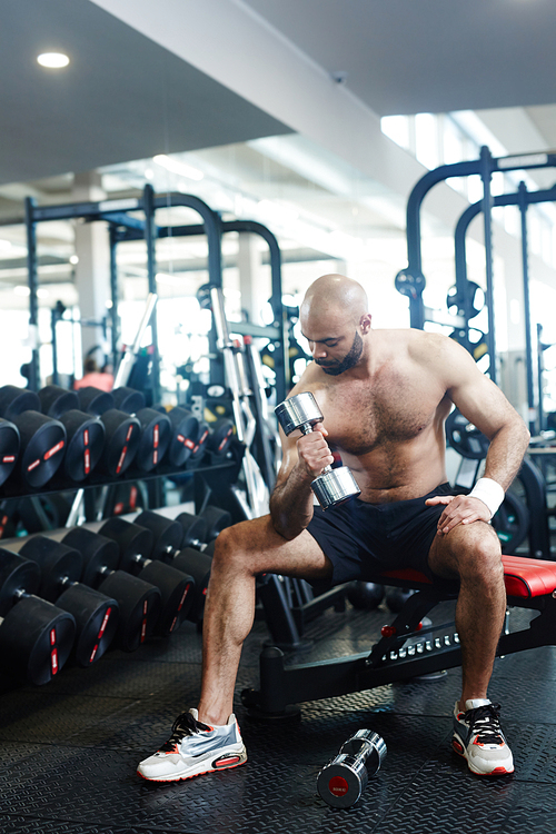 Young strong man training with barbell