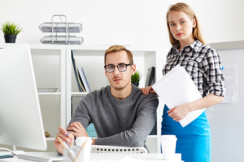 Young confident employees in casualwear  during work