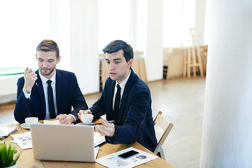 Confident economist presenting his report to colleague