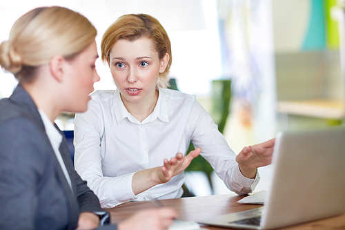 Businesswoman sharing her ideas with colleague and explaining data