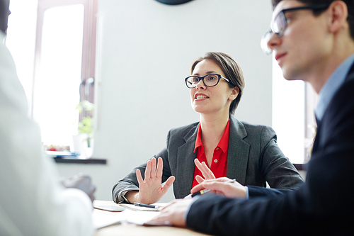 Businesswoman voicing details of company corporate culture to applicant during interview