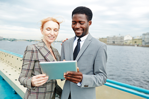 Business partners with tablet talking through video-chat on steamship