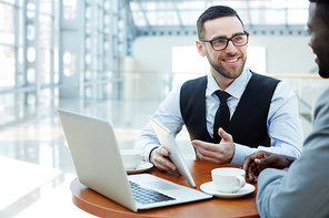 Happy economist showing online data to colleague