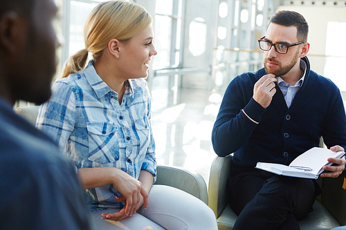 Pensive leader looking at his colleague during conversation