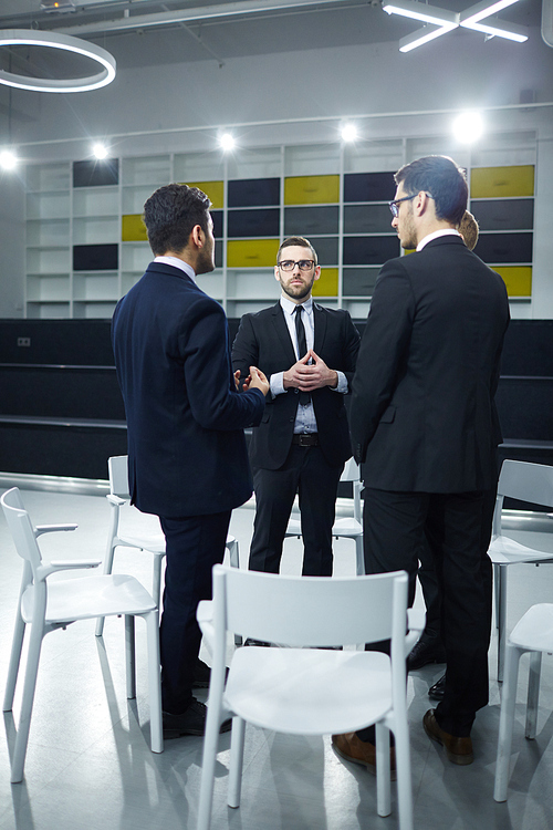 Circle of several stock-brokers interacting about business strategies after conference