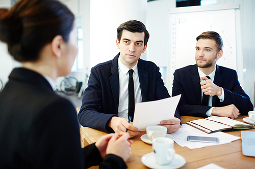 Employer listening to candidate for new vacancy with her resume