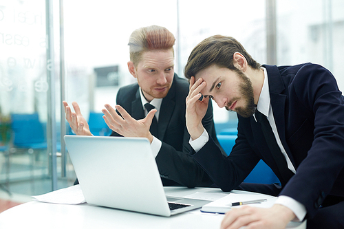 Frustrated businessmen looking for solution of problem