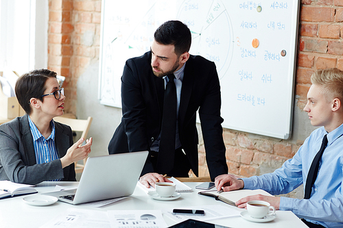 Businessmen listening to explanation of his colleague