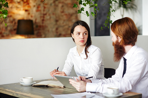 Two agents having discussion after work in cafe