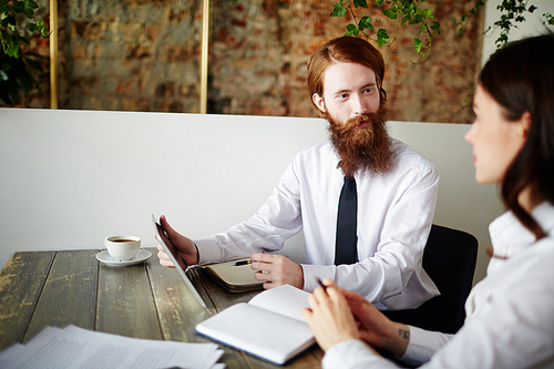 Confident analyst expalining his colleague online data at meeting