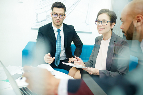 Team of co-workers working over project in office